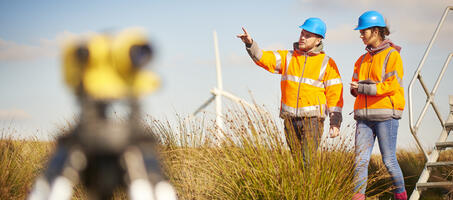 engineers working on the field with windmills